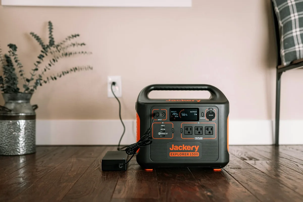A black and silver portable power station on a wooden table