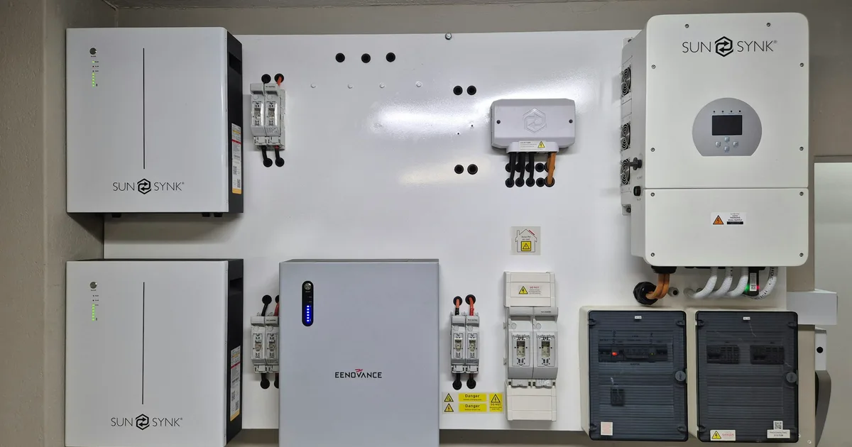 A wall-mounted home battery and energy storage system installed next to a house