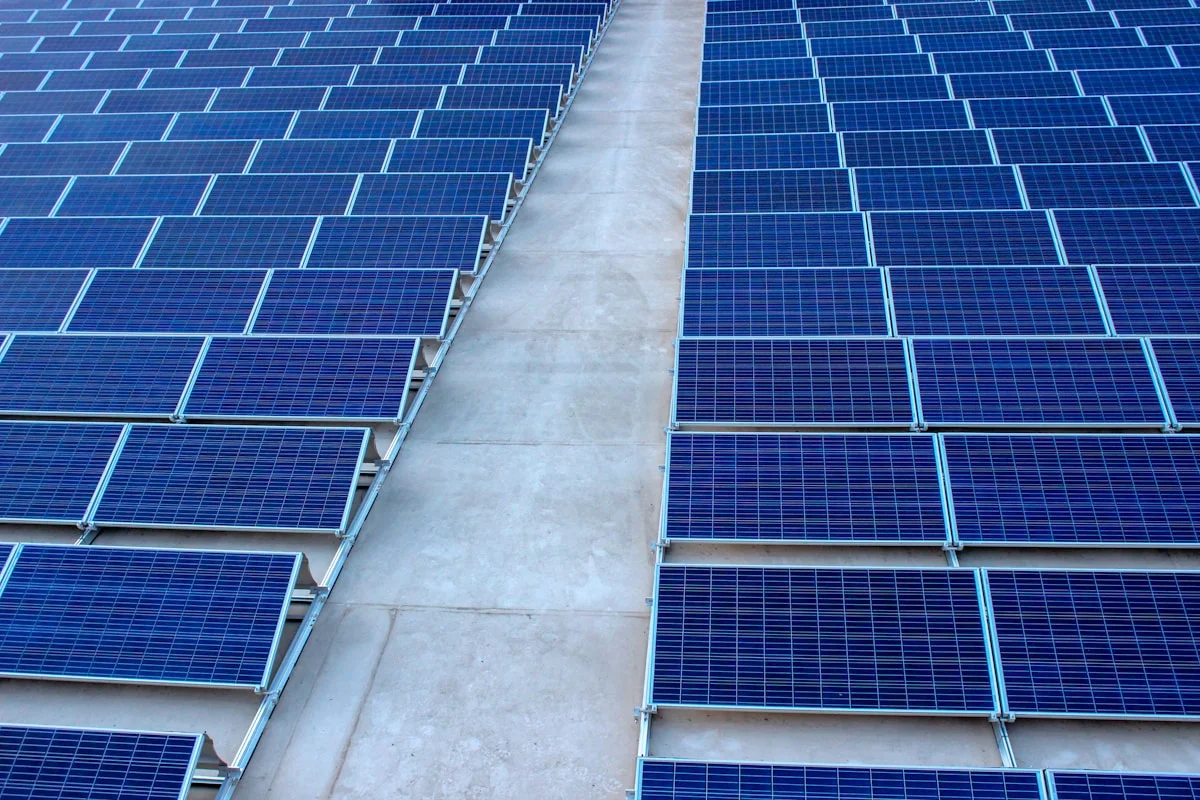 Rows of solar panels under a blue sky