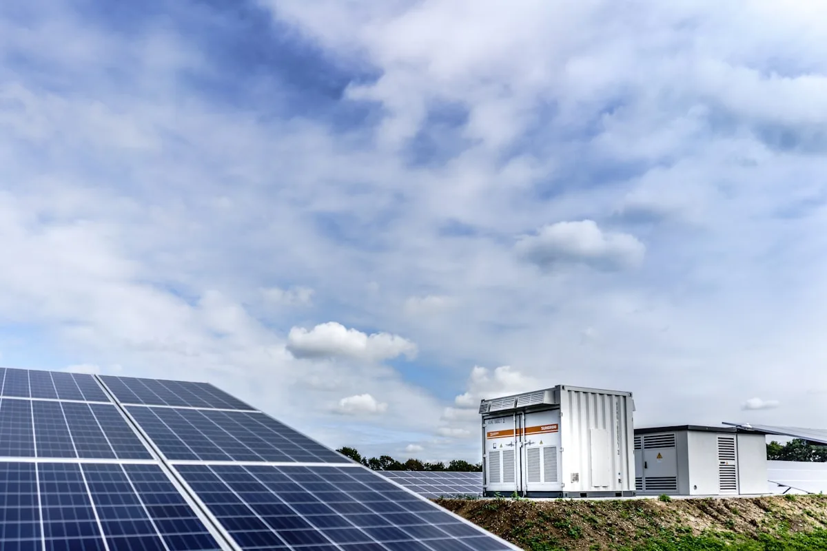 Technician inspecting solar panels on a rooftop checking for damage or defects