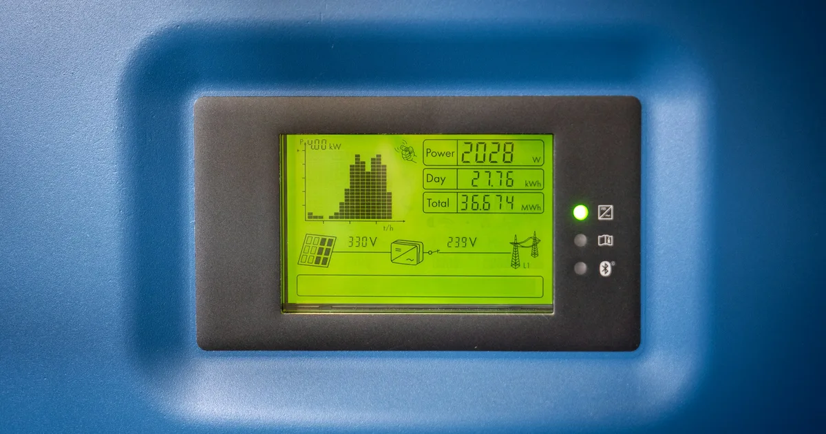 The display of a solar inverter showing real-time output, voltage and total energy figures
