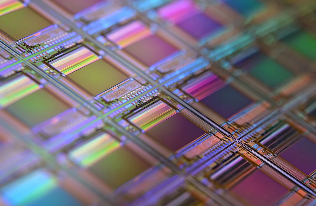 Cross-section view of a solar panel showing layered construction with glass front sheet, EVA encapsulant, silicon cells, backsheet, and aluminum frame