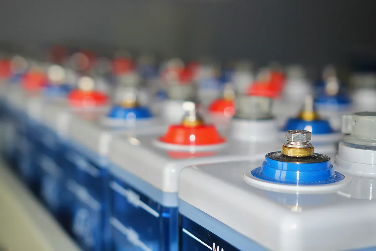 Rows of lead-acid storage cells with red and blue terminal posts