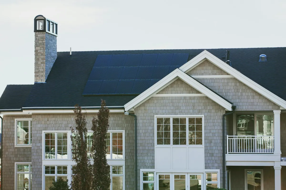 Suburban house with a small solar array on a dark pitched roof