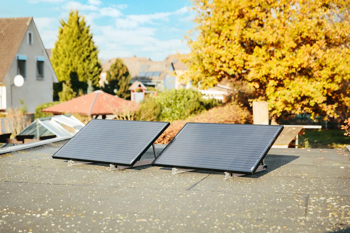 Roof panels ringed by autumn foliage, the season output drops hardest